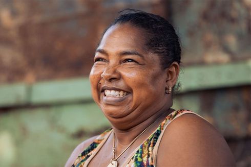 A close-up of a woman smiling. Climate change - Inter-American Development Bank - IDB