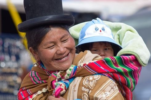 A person carrying a child. Information - Inter-American Development Bank - IDB